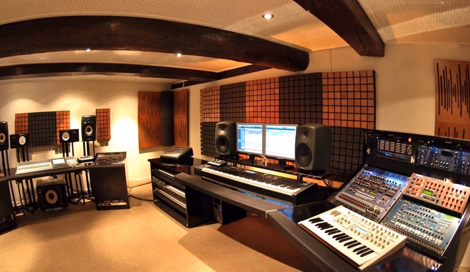 Production studio with keyboards and monitors
