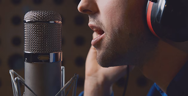 Voice artist dubbing at a studio microphone
